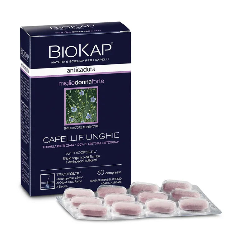 Biokap Anticaduta Miglio Donna Forte; rasia Biokap anticaduta -ravintolisää hiuksille ja kynsille, edessä liuska vaaleanpunaisia tabletteja; rasia suorakaiteen muotoinen, tummasävyinen kiiltävin violetein tehostein, etusivulla biotiinipitoinen kasvikuva; pääetiketti lihavoidulla valkoisella ja violetilla tikkukirjasimella; kuva tasaisella taustalla, ei ihmisiä tai rekvisiittaa näkyvissä.