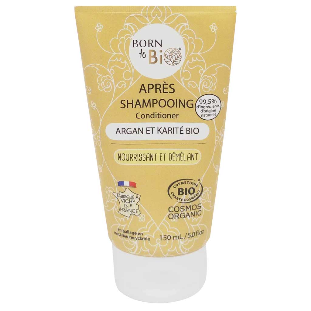 Born to Bio Conditioner 2in1; keltainen tuubi hoitoainetta arganilla ja sheavoilla, merkitty luomuksi ja Ranskassa valmistetuksi; 150 ml:n tuubissa ranskan- ja englanninkielistä tekstiä; muovinen mattapintainen puristustuubi pystyasennossa pyöristetyin kulmin; etiketissä eripainoista groteskikirjasinta; kuvattu vaalealla taustalla ilman ihmisiä tai käsiä.