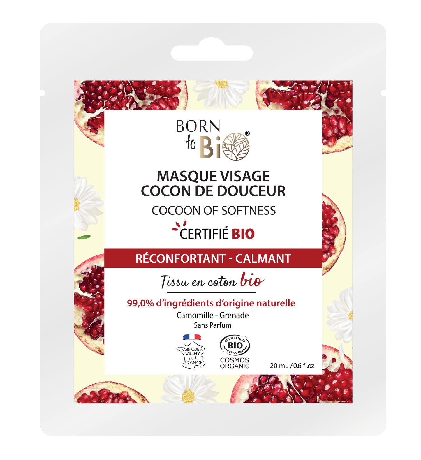 Born to Bio Cocoon of Softness -kasvokuorintapussi granaattiomenaviipale- ja kamomillakukkakuvin, sisältö 20 ml; joustava suorakaiteen muotoinen pussi kiiltäväpintaisena valkoisena ja pinkkinä, tuotenimi lihavoidulla groteskikirjasimella ja pienemmällä tekstillä luomusertifikaatti, 99 % luonnolliset raaka-aineet sekä rauhoittava kamomillauute; ei käsiä tai ihmisiä näkyvissä; tausta valkoinen, kuva otettu edestä.