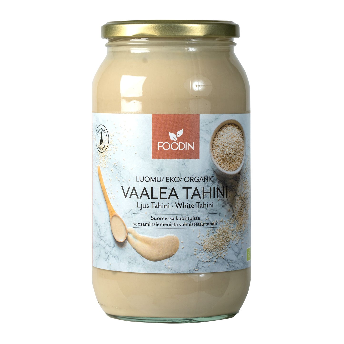Foodin Luomu Tahini Vaalea -purkki, lasinen, kultainen metallikierrekansi, mattaetiketti kuvin tahinista kulhossa ja lusikalla; teksti suomeksi, ruotsiksi ja englanniksi, "luomu" mainittu