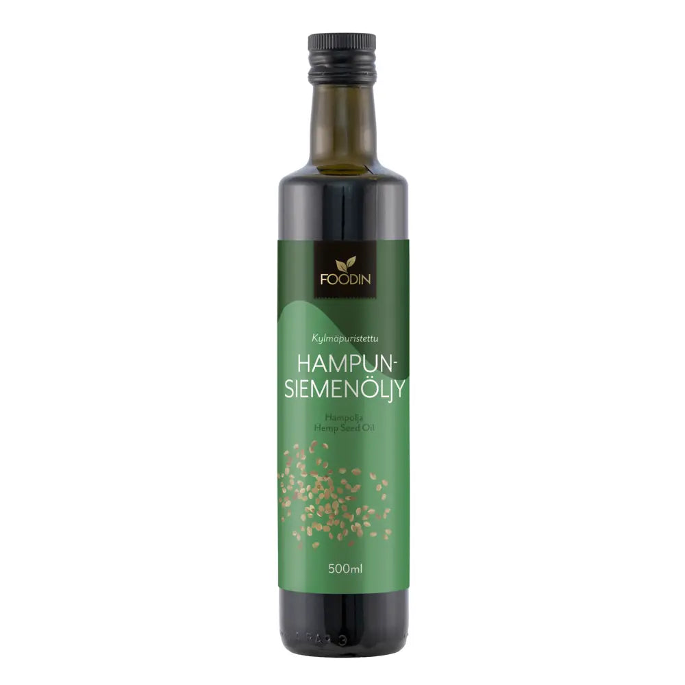 Foodin kylmäpuristettu hamppuöljy, 500 ml; vihreä etiketti suomeksi ja englanniksi; tumman ruskea tai musta lasipullo lieriömäisenä, mattapintaisena, kierrekorkilla; etiketissä kuva luomuhampunsiemenistä sekä yksinkertaista groteskitypografiaa; vaalea tausta, ei ihmisiä tai käsiä; hyvin valaistu, edestäpäin kuvattu tuote.