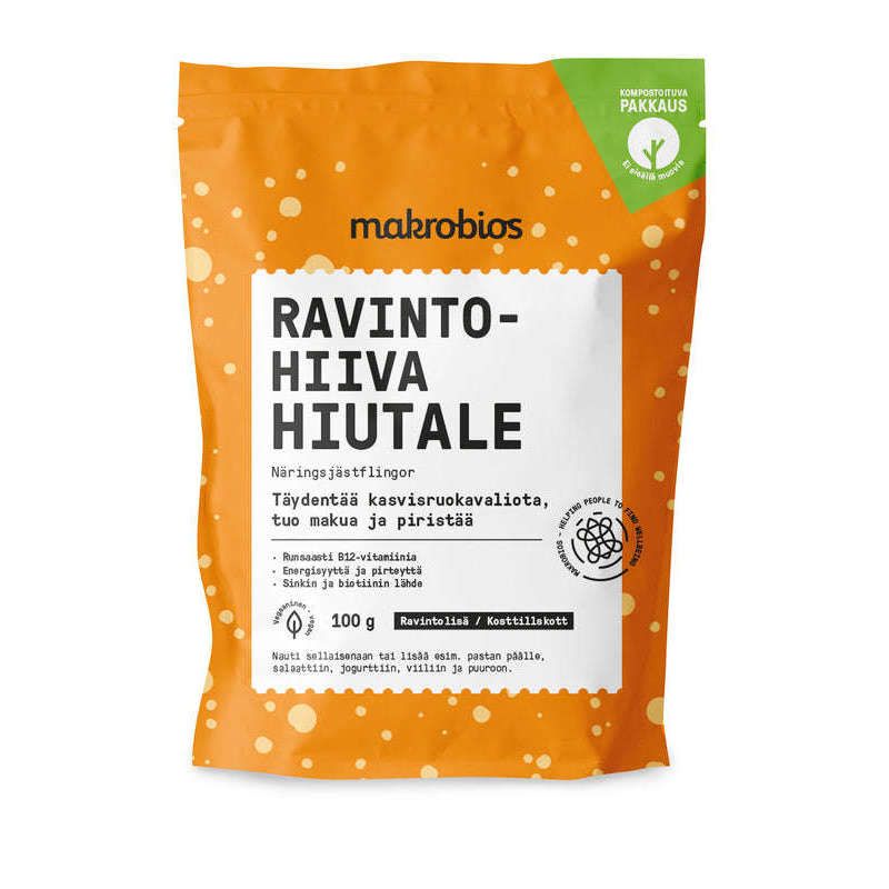 Makrobios Ravintohiivahiutale; oranssi pussi tekstillä "makrobios RAVINTOHIIVA HIUTALE", sisältää 100 g vegaanisia ravintohiivahiutaleita, valkoisin kuplakuvioin ja suomenkielisin tekstein korostaen B12-vitamiinipitoisia ainesosia; pakkaus suorakulmainen mattapintaisena uudelleensuljettavalla yläosalla; tuotenimi lihavoiduin versaalikirjaimin; valkoinen tausta, ei ihmisiä tai käsiä kuvassa.