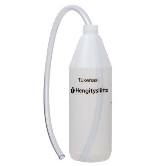 A clear plastic bottle labeled Tukenasi Hengitysliitto with a long, flexible tube attached to the top, designed for respiratory support and therapy. The bottle is cylindrical with a glossy finish and transparent surface. Black sans-serif typeface displays the label text horizontally on the front. No packaging or people visible. Neutral white background, photo taken from a frontal angle at eye level.