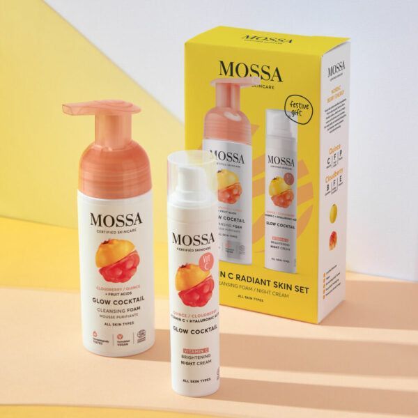 Mossa Vitamin C Lahjasetti; Glow Cocktail -ihonhoitosetti, jossa puhdistusvaahto, yövoide ja värikäs pakkaus pastellinkeltaisella ja pinkillä taustalla; tuotteissa on sylinterinmuotoisia tuubeja ja purkkeja kiiltävin valkoisin korkein ja monivärisin etiketein; pakkausten värit sisältävät oranssia, pinkkiä, keltaista ja violettia; typografia on lihavoitua groteskia; kuva on tasokuva ylhäältä, ei ihmisiä tai käsiä näkyvissä.
