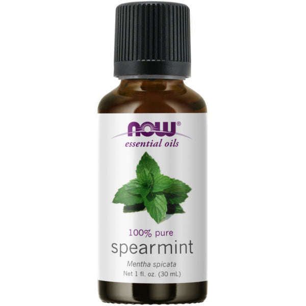 A brown glass bottle with a glossy finish is shown, featuring a rectangular white label. The label includes the NOW essential oils logo in purple block letters, an image of green spearmint leaves, and clear black and green printed text: 100% pure spearmint, Mentha spicata, Net 1 fl. oz. (30 mL). The bottle stands upright on a plain white background with no people or props visible.