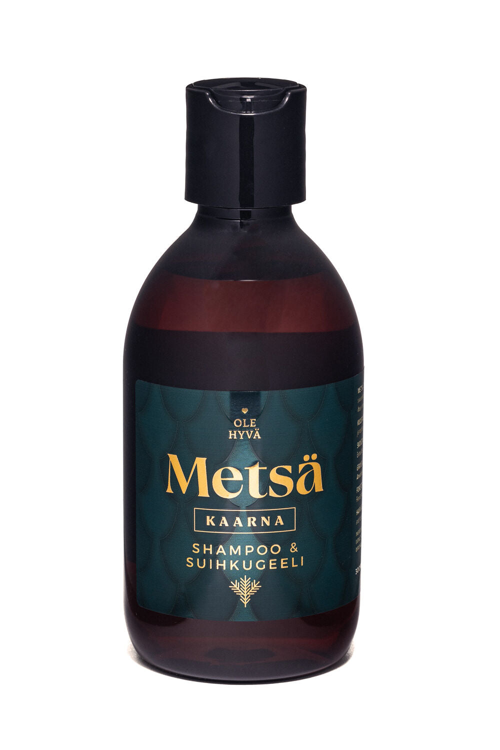 Tumman ruskea pullo mustalla korkilla, jossa lukee Ole Hyvä Metsä Kaarna Shampoo & Suihkugeeli, etiketissä turkoosia ja kultaista väriä; pullo lieriömäinen mattapinnalla; etiketti lihavoitua valkoista ja kultaista groteskikirjasinta turkoosilla pohjalla abstrakteine kuvioineen; tuote kuvattu pystyasennossa tasaisella neutraalilla taustalla, ei ihmisiä tai käsiä näkyvissä.