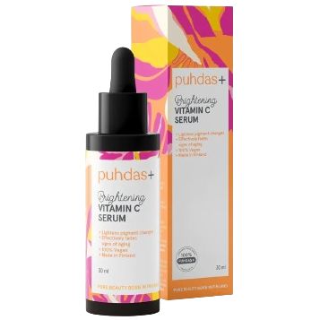 A bottle of puhdas+ Brightening Vitamin C Serum with a colorful label and a dropper is displayed in front of its matching box, highlighting its revitalizing formula. The bottle is cylindrical with a white dropper cap. The label has geometric color blocks and clear sans-serif text reading “puhdas+ Brightening Vitamin C Serum.” Both the bottle and box have matte finishes. White background, no people visible. Studio product shot.