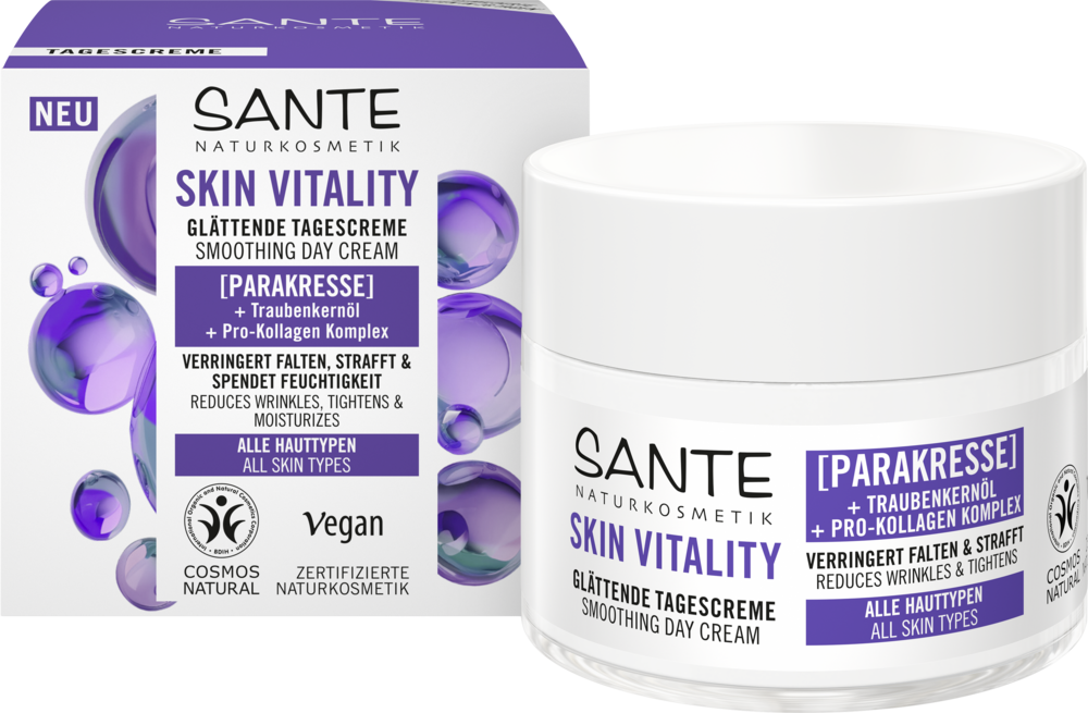 A box and jar of Sante Skin Vitality Smoothing Day Cream featuring purple accents, product details, and icons highlighting vegan and natural certification. The box is rectangular with a matte finish, white base, bold sans-serif typography, and clear logos. The cylindrical jar has a white cap and matching purple details. Both display concise label text. Set against a plain background in a product-focused shot. This nourishing formula is suitable for all skin types.