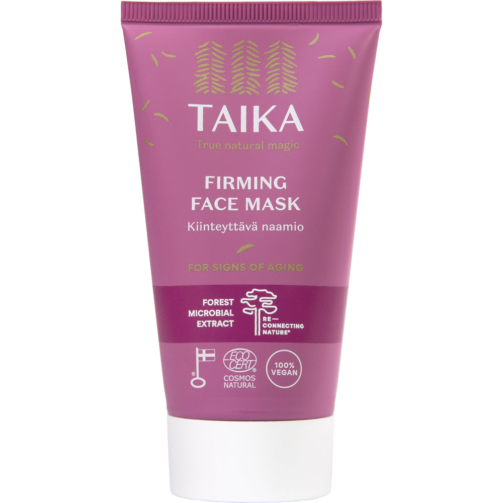 Taika Kiinteyttävä Naamio; vaaleanpunainen mattapintainen puristettava tuubi tekstillä TAIKA Firming Face Mask seisoo yksinään; valkoista groteskitekstiä ja yksinkertaisia logoja etuosassa, mukaan lukien maininta ikääntymisen merkeistä ja metsän mikrobiuutteesta; tuubi pystyssä ilman näkyvää kansidetaljia; tuotetyyppi ja pääainesosat näkyvissä pakkauksessa; neutraali tausta, ei ihmisiä tai rekvisiittaa.
