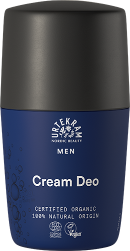 Urtekram Men Cream Deo, sininen-musta roll-on-deodoranttipullo tekstillä "Urtekram Nordic Beauty Men Cream Deo", sertifikaatit luomuainesosille ja vegaanituotteelle; sylinterimäinen muoto pyöristetyllä korkilla, mattapintaista muovia; lihavoitu valkoinen groteskitypografia sekä etiketissä että korkissa; tasokuva yksinkertaista valkoista taustaa vasten, ei ihmisiä eikä käsiä näkyvissä.
