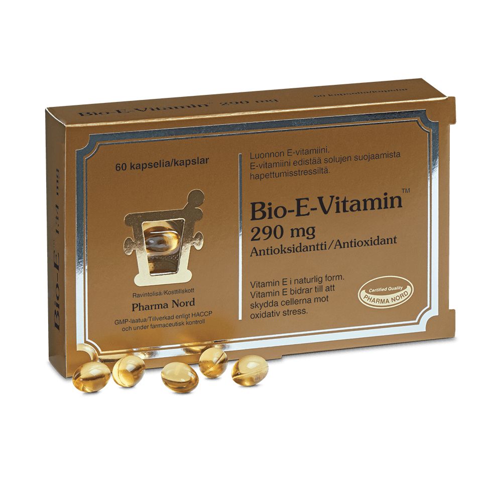 Bio-E-Vitamin 290 mg; kultainen suorakulmainen laatikko tekstillä "Bio-E-Vitamin 290 mg", 60 kapselia, useita läpikuultavia pehmytkapseleita aseteltuna laatikon eteen; pakkaus mattapintainen lihavoiduin mustin ja valkoisin typografioin; tuotetiedot ja antioksidanttihyödyt painettu selkeästi englanniksi ja suomeksi; valkoinen tausta, ei ihmisiä tai käsiä kuvassa.