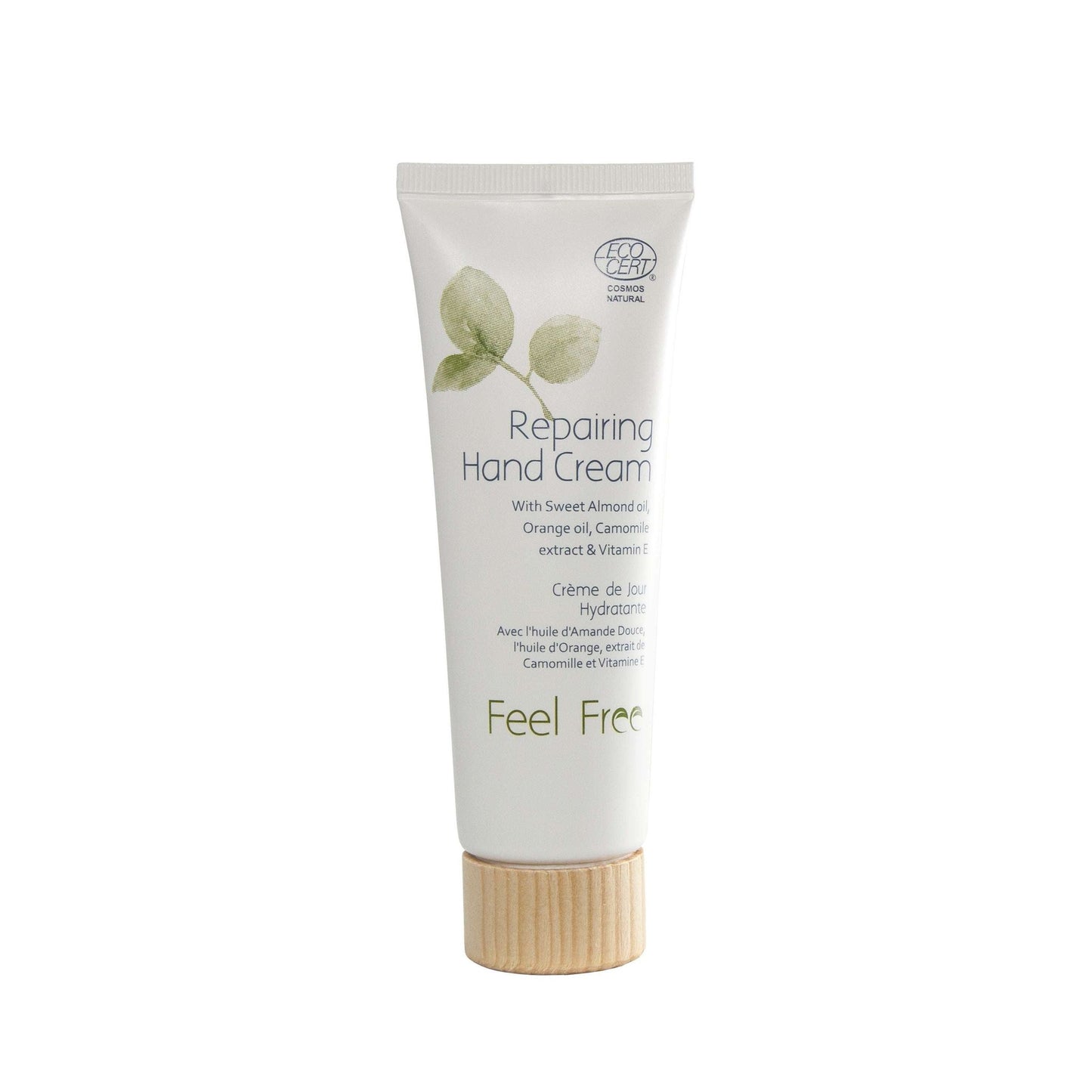 A white tube of Repairing Hand Cream with a matte finish and a cylindrical wooden cap, shown upright. The front label displays illustrations of green leaves and text mentioning chamomile extract, sweet almond oil, orange oil, and vitamin E in sans-serif typography. Plain background; no people or props visible.