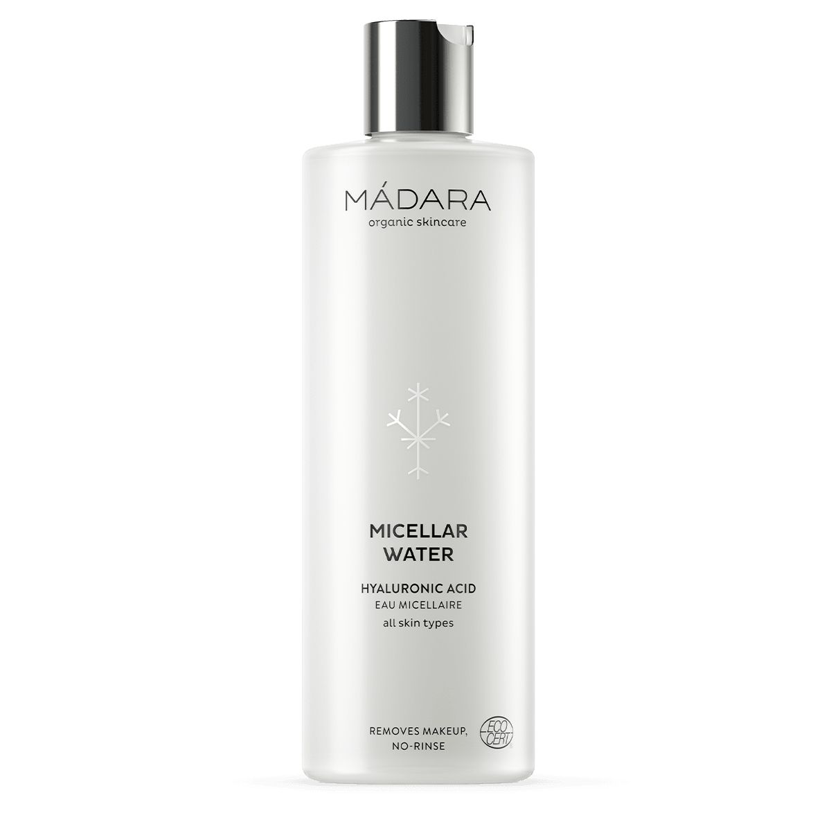 MÁDARA Misellivesi -pullo, kirkas, korkea sylinterinmuotoinen, musta kiiltävä korkki; valkoinen-hopeinen etiketti, groteskiteksti "MÁDARA" ja "Micellar Water"