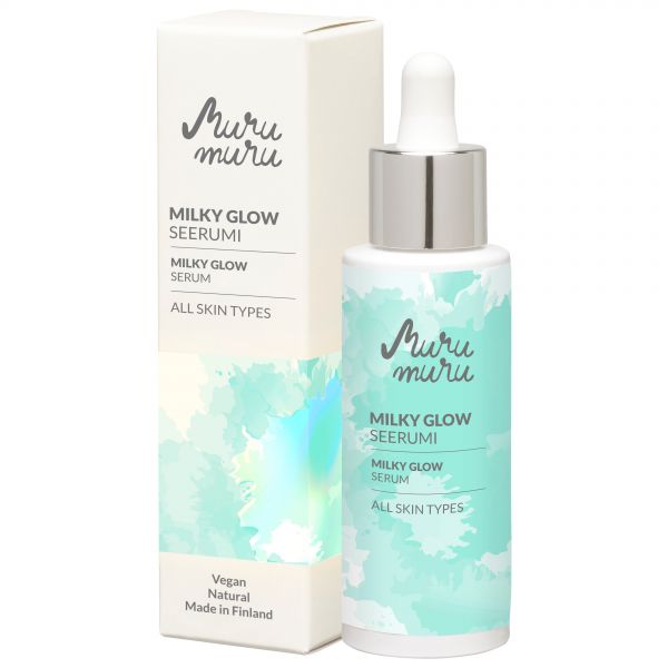 A bottle and box of Murumuru Milky Glow Serum for all skin types, featuring a blue and white design. Both items have a matte finish. The bottle is cylindrical with a pump dispenser; the box is rectangular. Typography is clean, sans-serif, with legible label text: vegan, natural, made in Finland with murumuru butter. Neutral background; no people or hands visible.