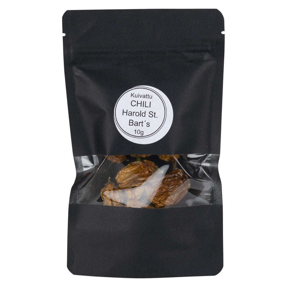A black, matte-finish, flexible resealable pouch with a rectangular clear window shows dried red chilies. The packaging has a white label with bold and regular mixed-case sans serif text: Kuivattu CHILI Harold St. Barts 10g. No people or actions visible. Product is centrally placed against a plain white background in a straight-on shot.