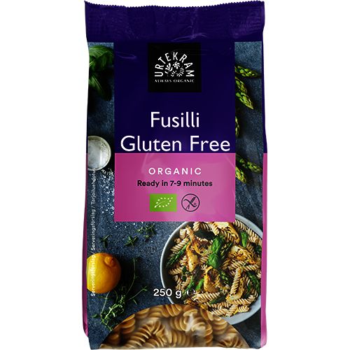Urtekram Gluteeniton Luomu Fusilli -pakkaus, 250 g, kuva keitetystä fusillista ja yrteistä lautasella; vaalea mattapintainen pakkaus, lihavoitu groteskiteksti, "organic", "gluten free", "ready in 7-9 minutes" mainittu
