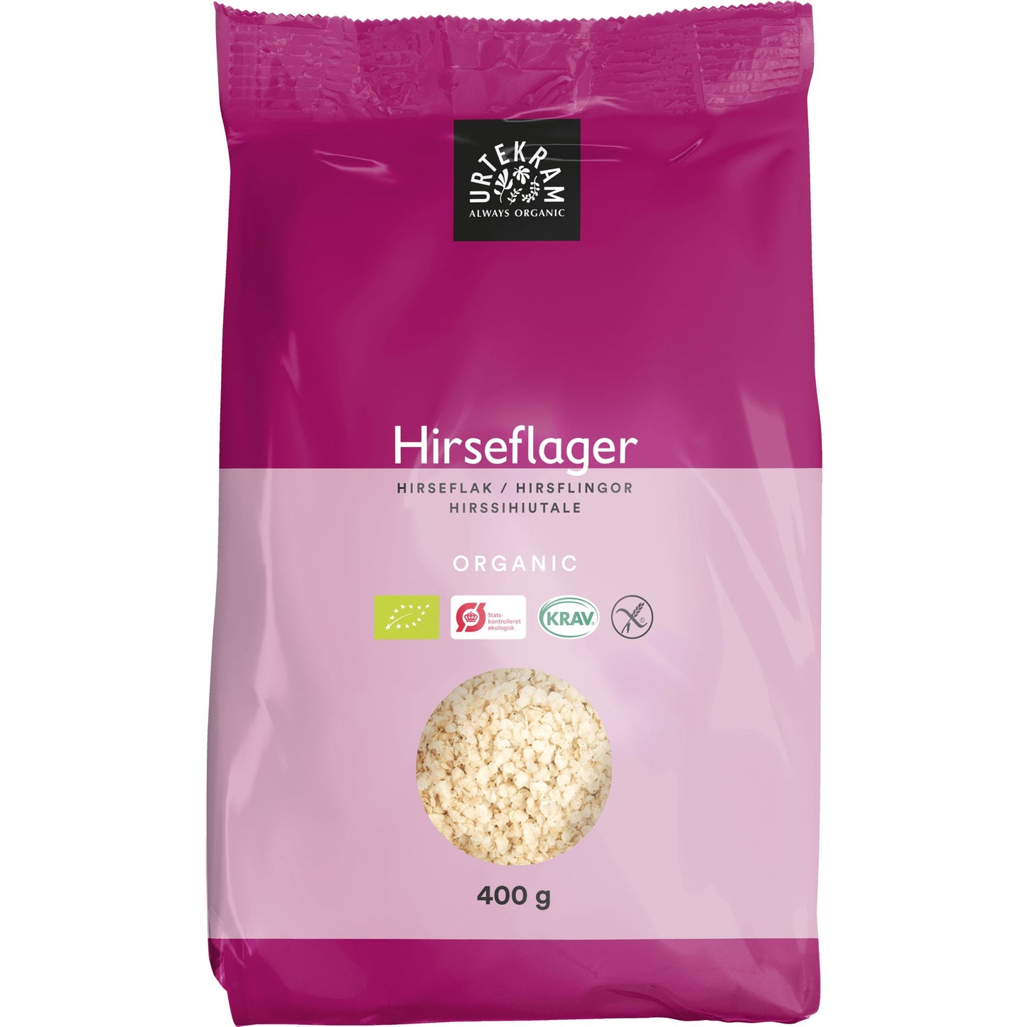 400 g:n pussi Urtekramin luomu-hirssihiutaleita. Pakkaus on vaaleanpunainen mattapinnalla, ja siinä on pyöreä läpinäkyvä ikkuna näyttämässä viljahiutaleet sisällä. Näkyvissä on sertifikaattimerkit luomulle, KRAV:lle ja gluteenittomuudelle. Tuotenimi on painettu lihavoidulla pääteviivattomalla fontilla. Ihmisiä tai käsiä ei näy; pelkistetty tausta, studiotyylinen tuotekuva.
