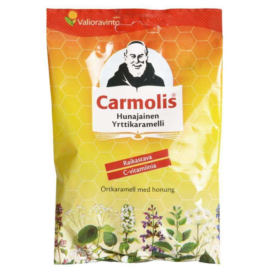Carmolis Yrttikaramelli Hunajainen -pussi; keltainen, kiiltäväpintainen ja pystysuuntainen suorakulmainen pussi; etupuolella yrttikuvitus sekä parrakkaan miehen kuvitus; suomen- ja ruotsinkielinen teksti, "Carmolis" mustin lohkokirjaimin ja muu teksti päätekirjasimella; kuvattu valkoista taustaa vasten, ei ihmisiä tai muita esineitä.