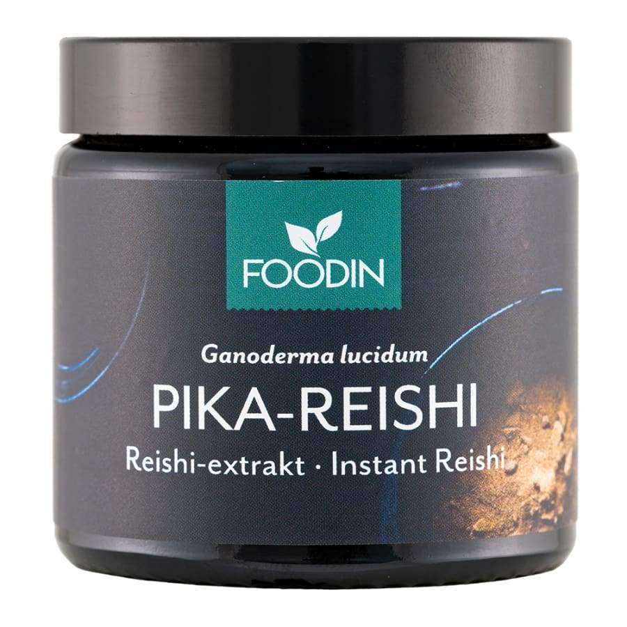 FOODIN Ganoderma lucidum PIKA-REISHI; tumma, lieriömäinen purkki, kierrekansi, läpinäkymätöntä materiaalia, mattapinta; sininen-ruskea etiketti kiertää purkkia, selkeää groteskitekstiä; teksti mainitsee "Reishi-extrakt · Instant Reishi" sekä laadukkaan reishiuutteen; vaalea tausta, ei ihmisiä tai esineitä.