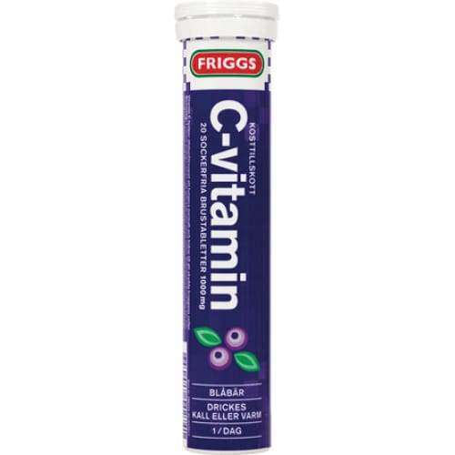 Friggs C-vitamiini-poretabletit, mustikka, ruotsinkielinen teksti; eloisa violetti pakkaus tuoreiden mustikkakuvien kanssa alaosassa; lieriömäinen putkilo kiiltävällä pinnalla ja valkoisella korkilla; groteskifonttia etikettitekstissä; tuote pystyssä vaalealla studiotaustalla, ei ihmisiä tai käsiä.