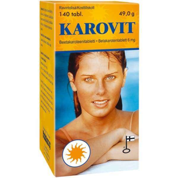 Karovit-pakkaus, nainen märillä hiuksilla etupuolella, suomenkielinen teksti, aurinko- ja Suomen lippu -kuvakkeet; suorakulmainen oranssi-keltainen mattapintainen pahvirasia, näkyvä groteskiteksti