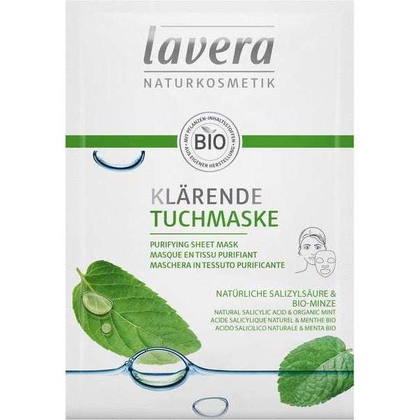 Lavera Purifying Sheet Mask Puhdistava kasvonaamio; suorakulmainen mattapintainen pussi valkoisena ja vihreänä, kuvituksena vihreitä minttulehtiä ja vesipisaroita; teksti saksaksi, englanniksi, ranskaksi ja italiaksi mainiten luonnollisen salisyylihapon ja luomumintun; groteskikirjasin; vaalea tausta, ei ihmisiä tai käsiä, yksinkertainen studiokuva.