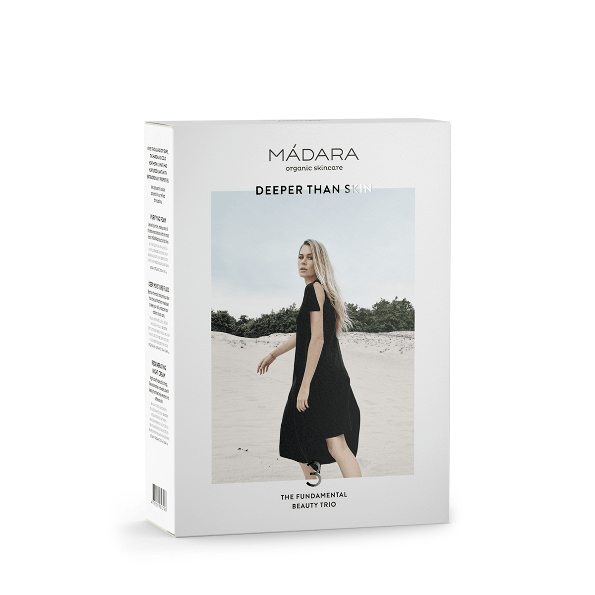 MÁDARA Become Organic -pakkaus, kuvassa nainen mustassa mekossa kävelemässä hiekalla, tekstissä "DEEPER THAN SKIN" ja "THE FUNDAMENTAL BEAUTY TRIO", korostaen luonnollisia raaka-aineita; suorakulmainen pakkaus mattapinnalla, valokuvaa ja tekstausvapaata typografiaa; vain osa tuotesarjasta näkyvissä; kuvan tausta valkoinen, studiokuva.