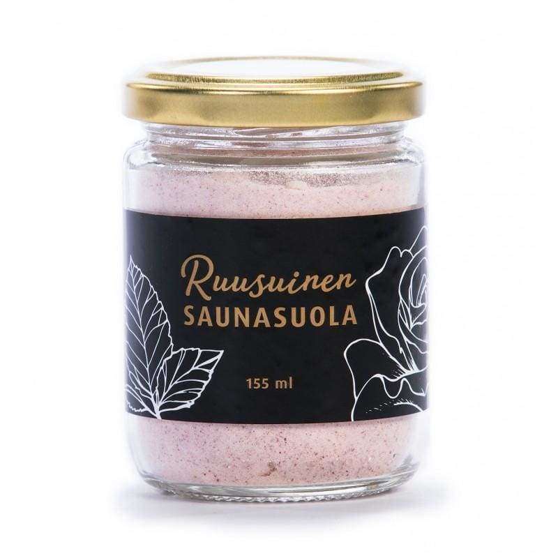 Tuisa Ruusuinen Saunasuola -purkki, 155 ml; sylinterimäinen ja läpinäkyvä lasipurkki kultaisella kannella, sisällä vaaleanpunaista saunasuolaa; mustassa etiketissä teksti "Ruusunen Saunasuola 155 ml" selkeällä päätekirjasimella sekä hienoa viivapiirrosta lehdistä ja ruusunkukasta; pakkauksen pinta mattamainen; kuvattu yksiväristä taustaa vasten.