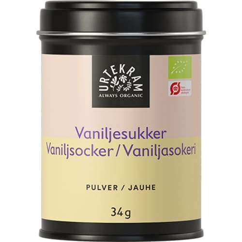 Urtekram Luomu Vaniljasokeri; 34 g peltirasia tekstillä "Urtekram" luomuvaniljasokeria, musta muovikansi; lieriömäinen metallipurkki mattabeigen paperietiketillä; etiketissä tuotetietoja useilla kielillä sekä reilun kaupan sertifiointilogoja; typografia yksinkertaista groteskia mustin ja sinisin kirjaimin; ei ihmisiä tai käsiä; kuvattu vaaleaa, neutraalia taustaa vasten.