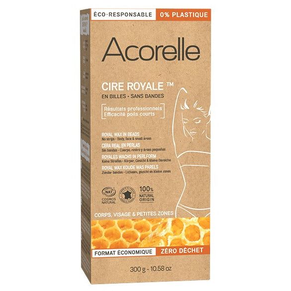 Acorelle Vaharakeet Karvanpoistoon: rasia Acorelle Cire Royale -vahaa karvanpoistoon, pakkauksessa mainitaan ympäristöystävällisyys ja muovittomuus; kuvituksena naishahmo ja hunajakennokuvio, merkitty käytettäväksi vartalolle, kasvoille ja pienille alueille; rasia on suorakulmainen ja mattapintainen, pääosin valkoinen keltaisin korostuksin; etiketissä käytetään sekä groteski- että antiikvafonttia; tuote kuvattu neutraalia taustaa vasten edestäpäin, ei ihmisiä tai käsiä näkyvissä.