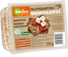 Pakkaus Balvitenin gluteenitonta siemenleipää, merkitty Gluteeniton Siemenleipä!, jossa on kaksi viipaletta tomaatilla ja fetalla päällystettynä. Merkitty myös vegaaniksi, runsaskuituiseksi, maidottomaksi ja 250 g:ksi. Suorakulmainen muovipakkaus läpinäkyvällä osalla, joka näyttää leivän sisällä; etuetiketissä on lihavoitua pääteviivatonta typografiaa valkoisena ja vihreänä keltaisella pohjalla. Ihmisiä tai käsiä ei näy; tausta on valkoinen. Suoraan edestä otettu tuotekuva.