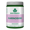 Bioteekki Karnosiini; vihreä-valkoinen purkki tekstillä "BIOTEEKKI KARNOSIINI" violetilla nauhalla, sisältää 60 kapselia; muovipurkki mattapinnalla, lieriön muotoinen kierrekorkillinen; etiketti lihavoitua sans-serif-tekstiä lohkokirjaimin eri fonttipainoin; pääteksti sisältää "AMINOHAPPO", "PITKÄVAIKUTTEINEN" ja "HELPPOSTI NIELTÄVÄ" aminohappokaavasta; kuvattu valkoista taustaa vasten, ei ihmisiä tai toimintaa näkyvissä.