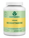 Bioteekki Vegan Monivitamiini, valkoinen muovipullo sylinterimäinen kierrekorkilla ja mattapinnalla; etiketissä vihreitä ja keltaisia korostuksia; typografia moderni groteski, pääteksti "Bioteekki Vegan Monivitamiini", muu tieto sisältää "90 tablets"; ei ihmisiä eikä käsiä näkyvissä, tausta yksinkertainen studiokuva; pullo sisältää 90 tablettia vegaanisia monivitamiineja kasvipohjaisen elämäntavan tueksi.