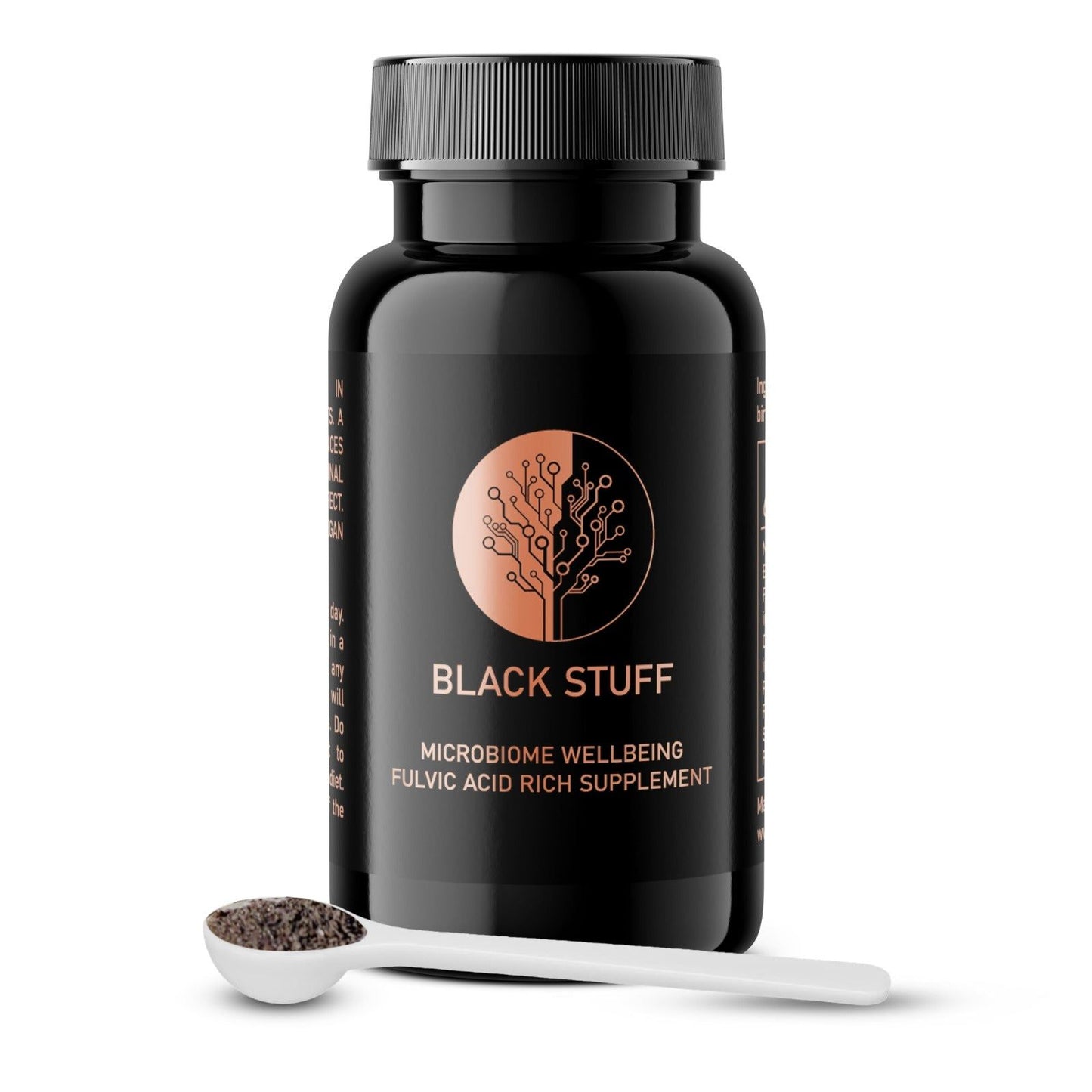 A black, cylindrical supplement bottle with a matte surface finish displays the label “Black Stuff,” a tree graphic, and text including “Microbiome Wellbeing Fulvic Acid Rich Supplement” in clear sans-serif fonts. It stands beside a glossy white spoon containing coarse, dark granules. The objects are arranged on a plain, light background. No people or hands visible.