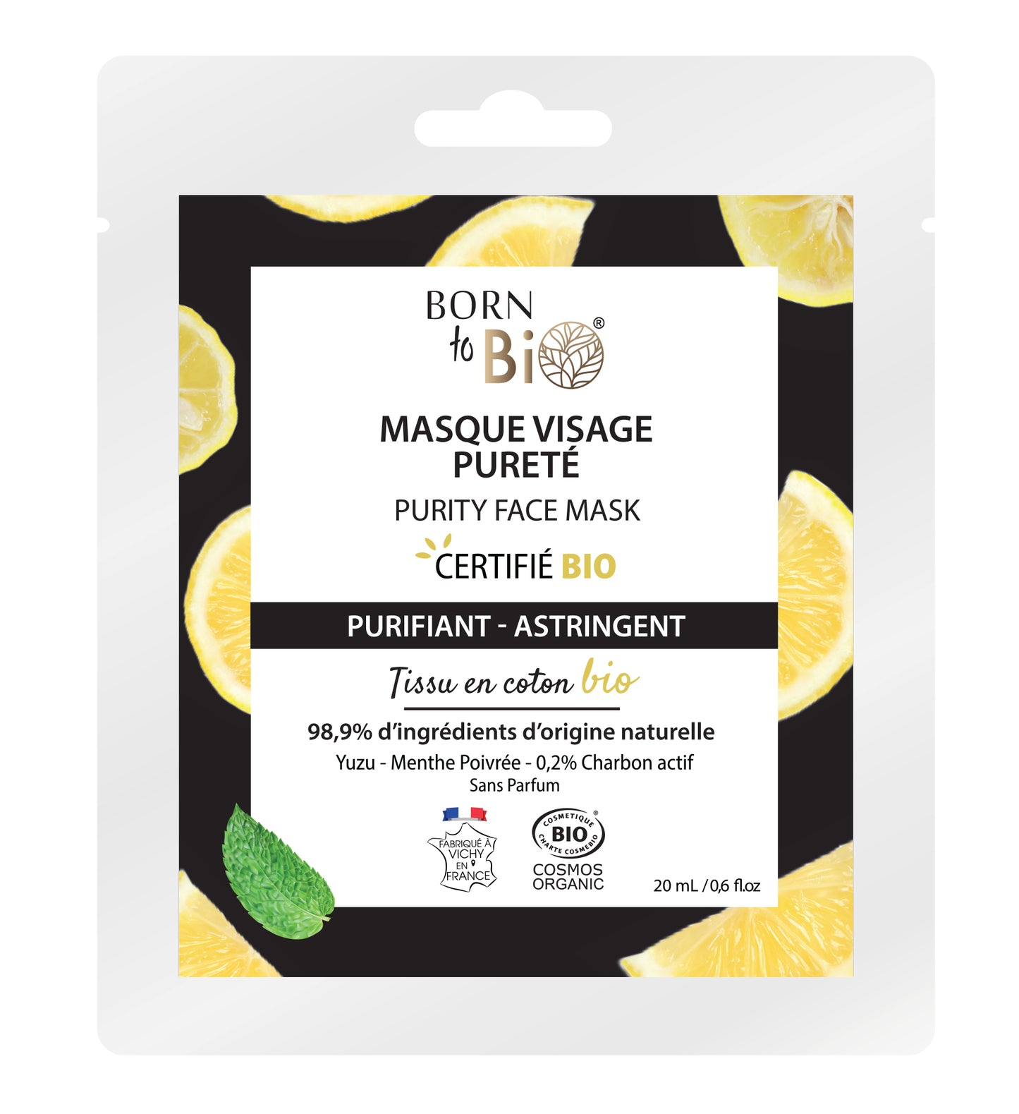Born to Bio Purity Face Mask -pakkaus sitruunaviipalein ja minttulehdellä mustaa taustaa vasten; joustava pussipakkaus mattavalkoinen vihrein yksityiskohdin ja pyöristetyin kulmin; yksinkertainen groteskikirjasin brändinimelle ja tuotetiedoille; näkyvissä luomusertifikaattimerkinnät ja luonnollisten raaka-aineiden luettelo; ei ihmisiä tai käsiä näkyvissä kuvassa.