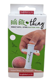 A hand uses a white plastic bug bite suction tool on a red bite visible on skin. The tool is cylindrical with a matte finish. The product box is partly shown, featuring green and black sans-serif text stating “Bug Bite Thing” and referring to instant relief and reusability. The background is plain white. A hand uses a white bug bite suction tool on a red bite, as shown on the Bug Bite Thing box, an effective insect sting relief product. The packaging highlights instant relief and reusable features.