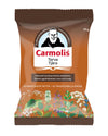 A brown matte-finish bag of Carmolis Terva Tjära throat lozenges stands upright. The packaging features an illustration showing a monk surrounded by herbs and flowers on the front. Product text is clearly shown in Finnish and Swedish. Label indicates a weight of 75 grams. No people, hands, or additional props are visible; background is plain and neutral.