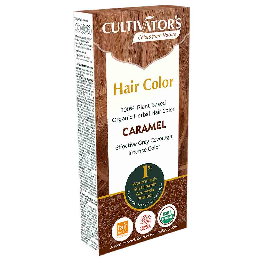 Cultivators Kasvihiusväri Caramel -pakkaus; suorakulmainen, mattapintainen rasia maanläheisissä sävyissä vihrein tekstikorostuksin; etiketissä teksti tuotteen 100-prosenttisesta kasviperäisyydestä, luomulaadusta ja tehokkaasta harmaan peittävyydestä; useita sertifiointimerkkejä näkyvissä; lihavoitu tekstausvapaa merkki ja tuotenimi, pienempää tekstiä ominaisuuksista; kuvattu valkoista taustaa vasten, ei ihmisiä tai käsiä näkyvissä.