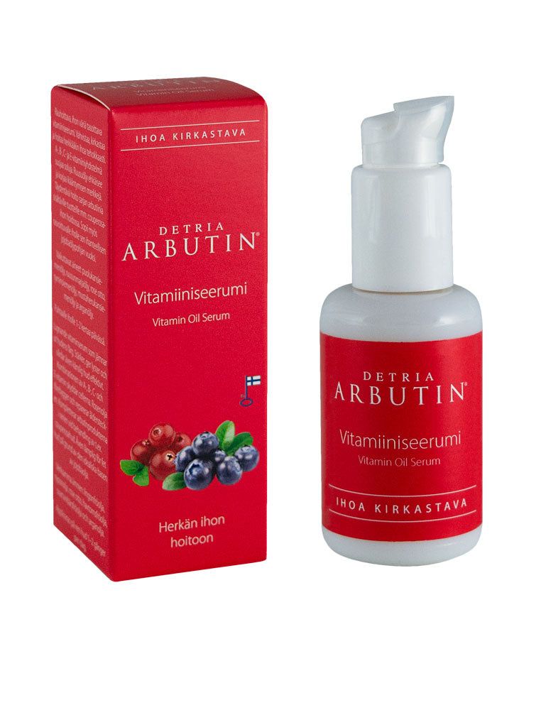 A red box and a matching bottle labeled Detria Arbutin Vitamiiniseerumi Vitamin Oil Serum are pictured; both have a matte finish. The box includes printed berries and a Finnish flag graphic, with readable product benefit text in sans-serif font. The background is plain, with no visible people or hands. The image is a straight-on product shot.