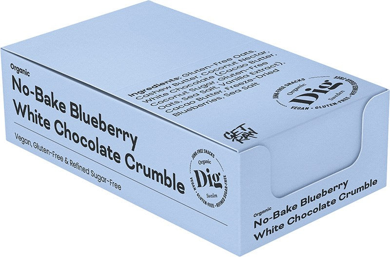 Dig Luomu Mustikka-Valkosuklaacrumble; vaaleansininen laatikko Digin luomu No-Bake Blueberry White Chocolate Crumble -tuotetta, merkitty vegaaniseksi, gluteenittomaksi ja puhdistetusta sokerista vapaaksi; ainesosat painettu laatikon yläosaan; pakkaus on suorakulmainen mattapinnalla; groteskifontteja käytetään tuotenimessä ja merkinnöissä; tausta valkoinen, ei ihmisiä tai esineitä näkyvissä; tuotekuva suoraan edestä ilman muuta rekvisiittaa.