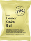 A yellow rectangular snack package with a matte finish is labeled Dig in large bold black font. The package also displays “organic Lemon Cake Ball,” and lists vegan, gluten-free, and refined sugar-free with simple sans-serif text. No people or props are visible. The background is plain white. A yellow snack package labeled Dig contains an organic Lemon Cake Ball. Vegan, gluten-free, and refined sugar-free ingredients and features are listed on the front in black text.
