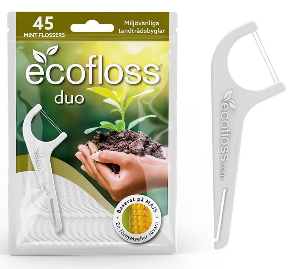 Ecofloss Duo Hammaslankain; pakkaus ecofloss duo -minttuhammaslankaimia, etupuolella käsi pitelemässä maata pienen taimen kera; pakkauksessa keltainen maissikuvake ja tekstiä kasvipohjaisesta materiaalista ja mintun mausta; pakkauksessa lähikuva yhdestä valkoisesta Y-muotoisesta hammaslankaimesta sileäpintaisena; typografia on groteskia ja lihavaa; tausta valkoinen, ei muita esineitä tai ympäristöä näkyvissä.