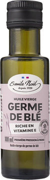 A 100ml bottle of Emile Noël wheat germ oil with a light pink label, highlighting its cold-pressed production and richness in vitamin E. The container is dark glass with a cylindrical shape and screw cap. The label shows simple sans-serif fonts in black and white. Photography background is plain white, no people or hands are visible, product photographed upright at center.