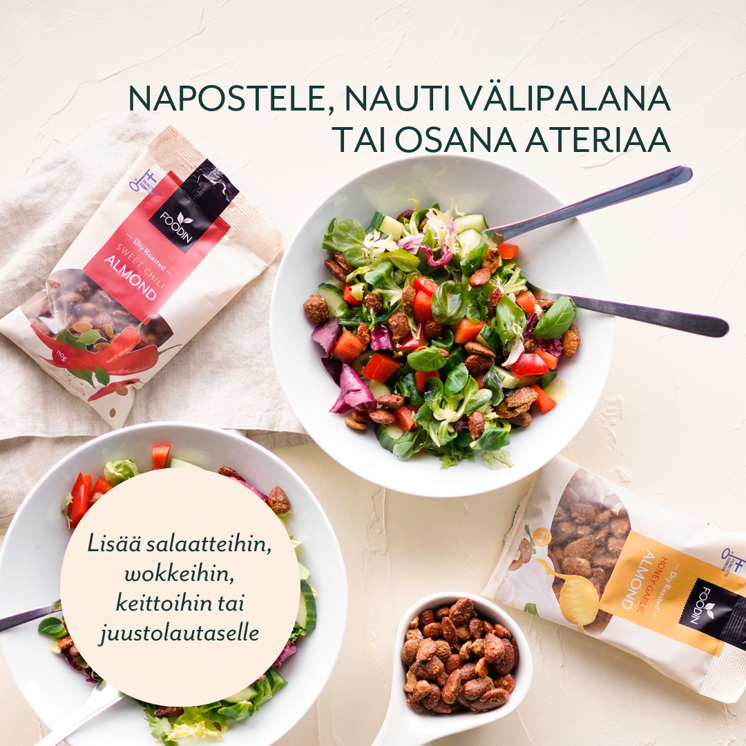 Two bowls of salad with nuts, two nut snack bags, and a small bowl of nuts on a light surface. Salad bowls are round and ceramic; the snack bags are rectangular with resealable tops, featuring clear Finnish text and stylized imagery. Small bowl is white ceramic. No people or hands visible. Flatlay shot in soft lighting. Finnish text encourages adding nuts to salads, stir-fries, soups, or cheese platters, and enjoying them as a nutritious snack or meal addition.