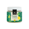 A jar of Foodin Green Superfood powder, featuring a fresh lemon-lime flavor, 120g. Cylindrical plastic or glass container with a matte green label and black screw-on lid. Label shows clear images of lemon, lime, leafy greens; main text in bold white and yellow fonts specifies probiotics and superfoods. Neutral background; no people or actions shown. Studio-style front product shot.