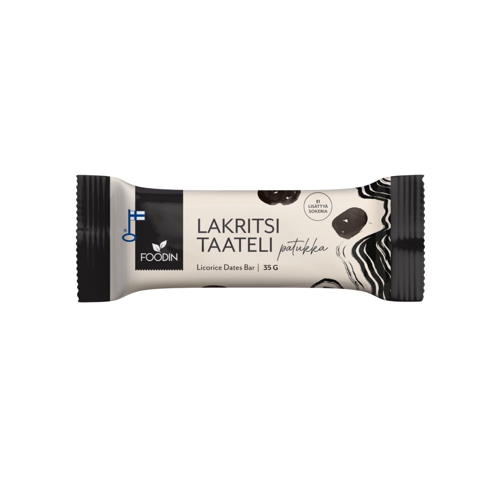 A wrapped Foodin Lakritsi Taateli licorice dates bar, 35g, on a white background. The rectangular packaging has black, white, and beige colors with matte finish; it shows clear images of soft licorice pieces and dates. Product type and weight are printed in bold sans-serif font. No people or hands are visible in the image.