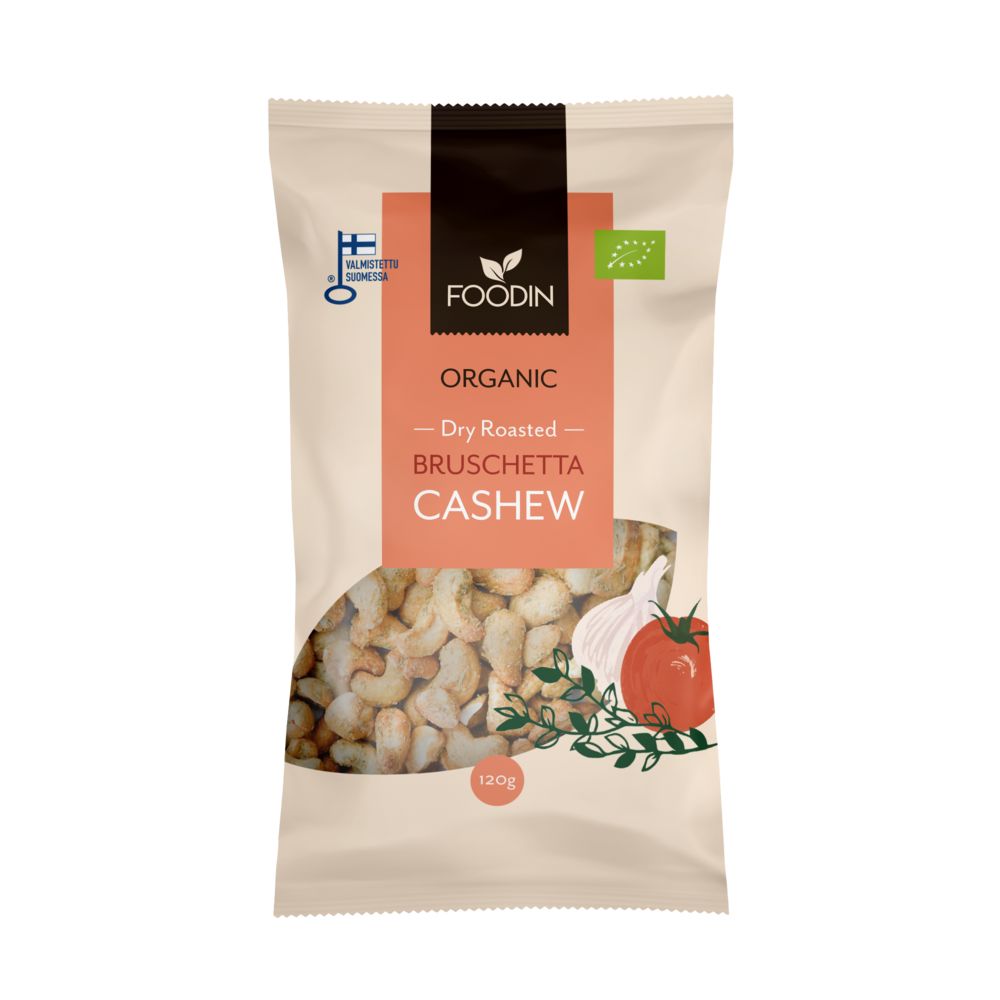 A beige bag of Foodin Organic Dry Roasted Bruschetta Cashew, 120g. The matte pouch is rectangular with a resealable top. Front graphics show cashew nuts and a red tomato illustration. Organic certification icons are printed below the product name in bold sans-serif font. No people or hands are present; product is isolated on a plain background.