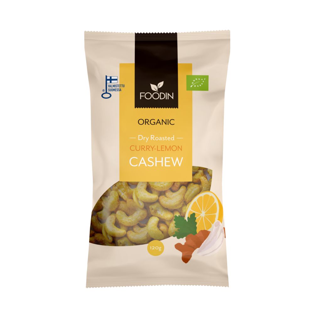 A beige bag of Foodin organic dry roasted curry-lemon cashews, featuring images of cashews, lemon, and spices on the front, along with an organic certification symbol in the top right corner. Matte finish packaging with a rectangular shape. Font is bold and modern. The bag stands upright against a plain background in a product-only studio shot. No people or hands visible.