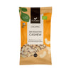 A 140g bag of Foodin Organic Dry Roasted Cashew nuts with orange, yellow, and brown matte packaging; rectangular, stand-up pouch shape. Labels display organic and Finnish certification logos near the top. Clear section on front shows whole cashew nuts inside. Sans-serif typeface used for legible product name text. Package is unopened and positioned upright against a plain white background in a studio shot.