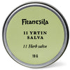 Pyöreä metallitölkki, jossa on vaaleanvihreä etiketti, jossa lukee "Frantsila 11 Yrtin hoitosalva, 19 g", on kuvassa keskellä valkoisella pohjalla. Tämä ihoa hellävaraisesti elvyttävä salva on Frantsilan valmistama.
